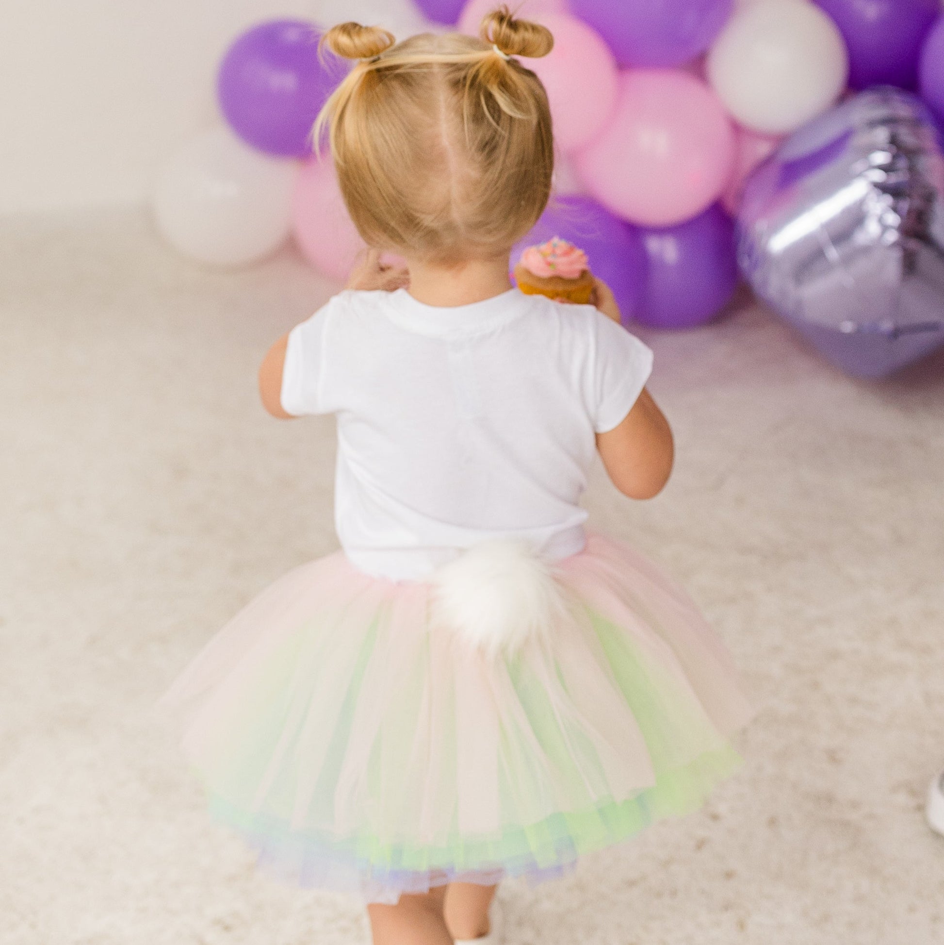 Our ten layered Pastel Rainbow tutu is a perfect addition to anyones wardrobe.  The soft pastel pink, green, purple, blue and white goes with many spring outfits! The fluffy bunny cottontail is removable for a easy transitional piece.