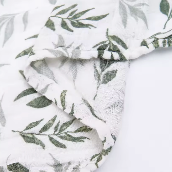 Fabric with green leaf pattern on a white background