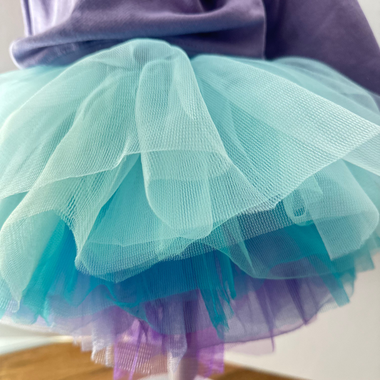 Light blue and purple tutu on a mannequin against a neutral background