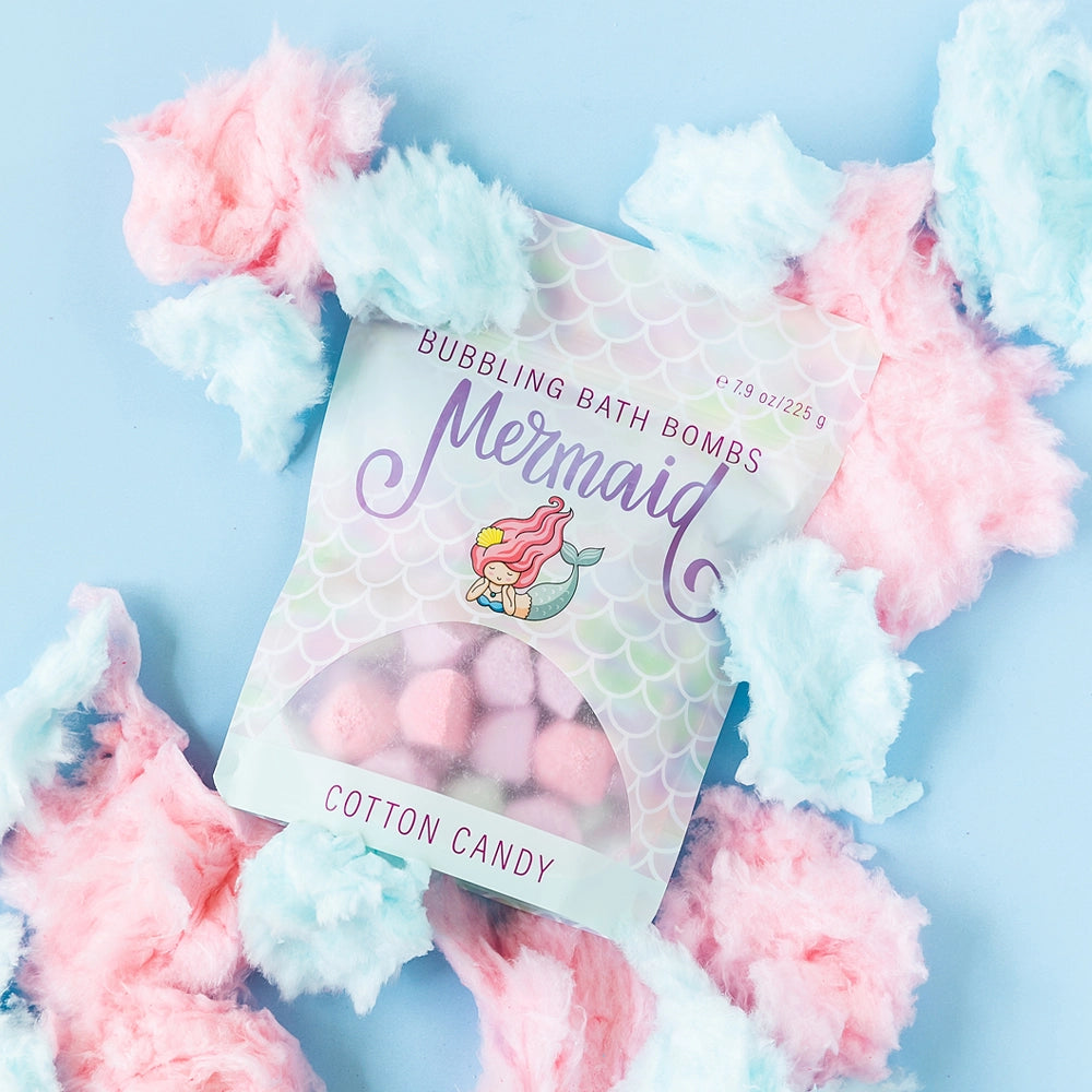 Mermaid-themed bubbling bath bombs packaging with cotton candy theme on a light blue background.