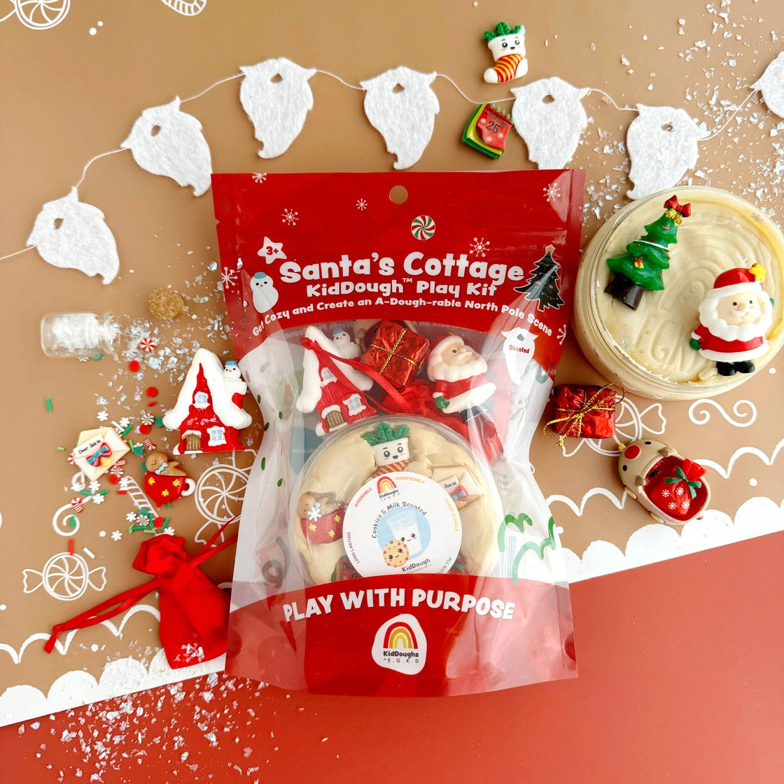 Santa's Cottage Kid Dough Play Kit with Christmas-themed decorations on a festive background