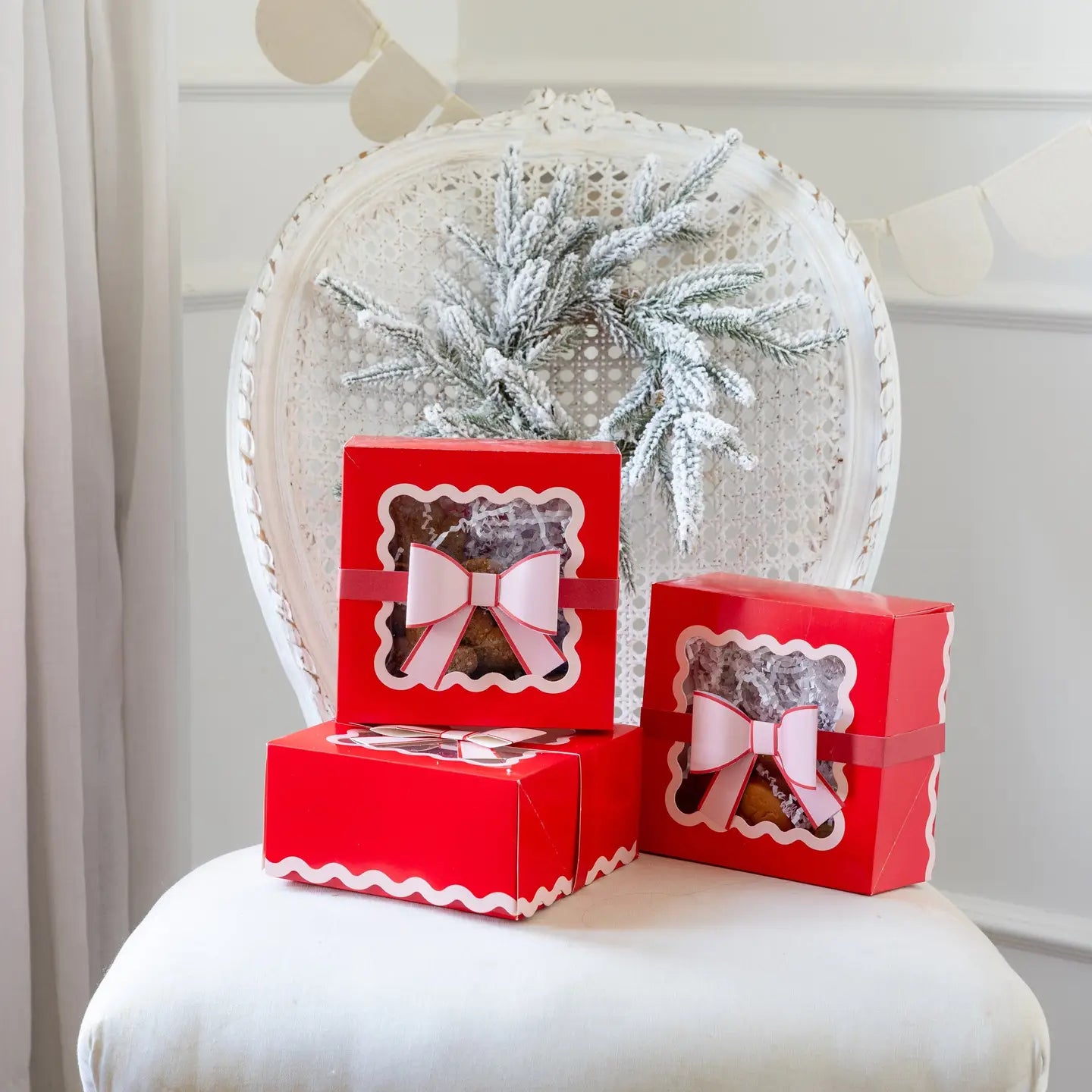 Red gift boxes with bear illustrations on a white chair