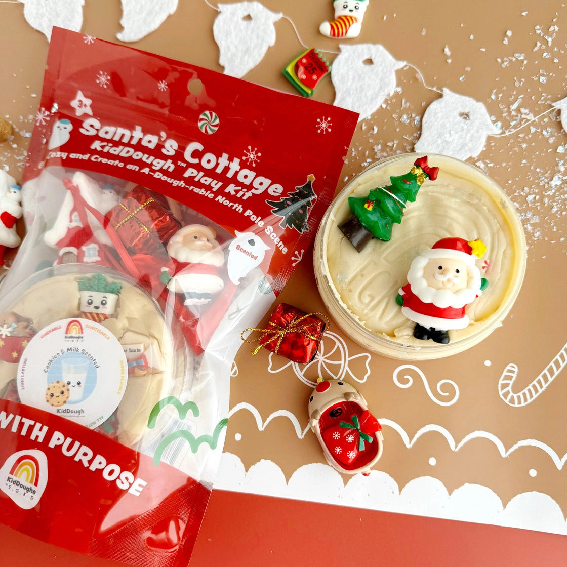 Santa's Cottage Playdough Kit with Christmas-themed playdough and decorations on a decorative background.