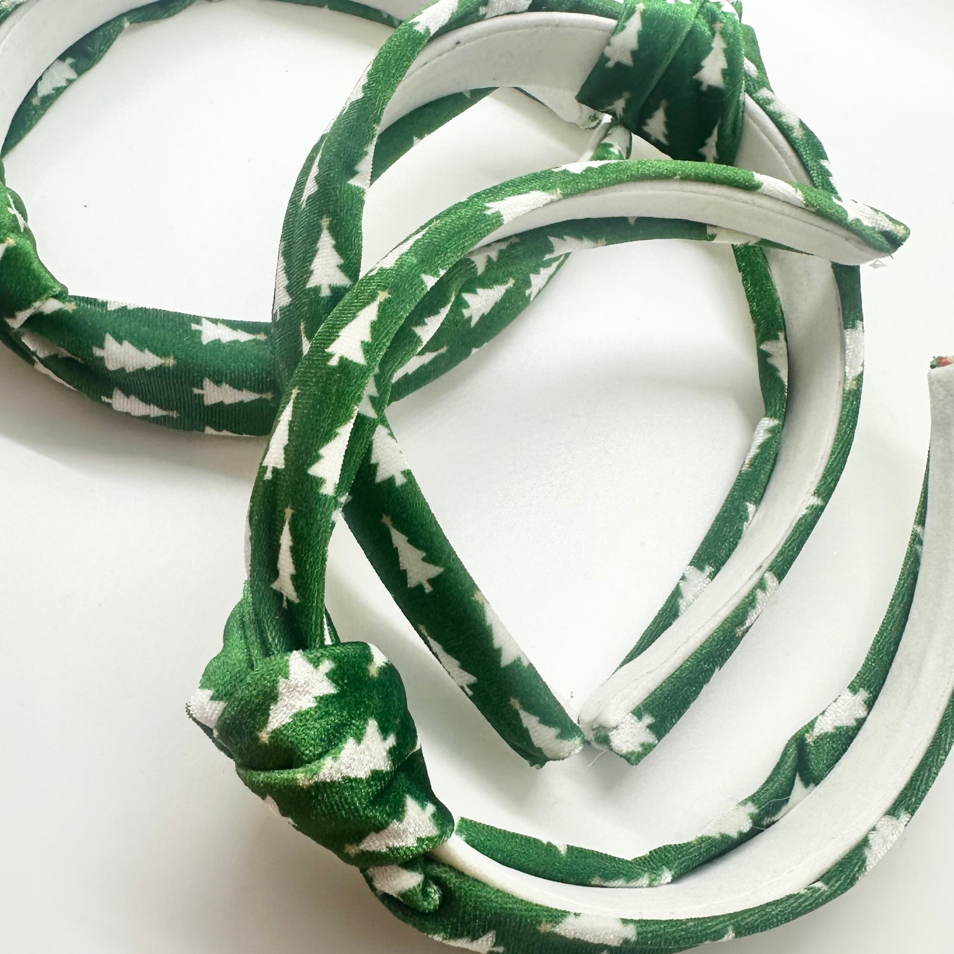 Green velvet headband with white Christmas tree pattern and top knot