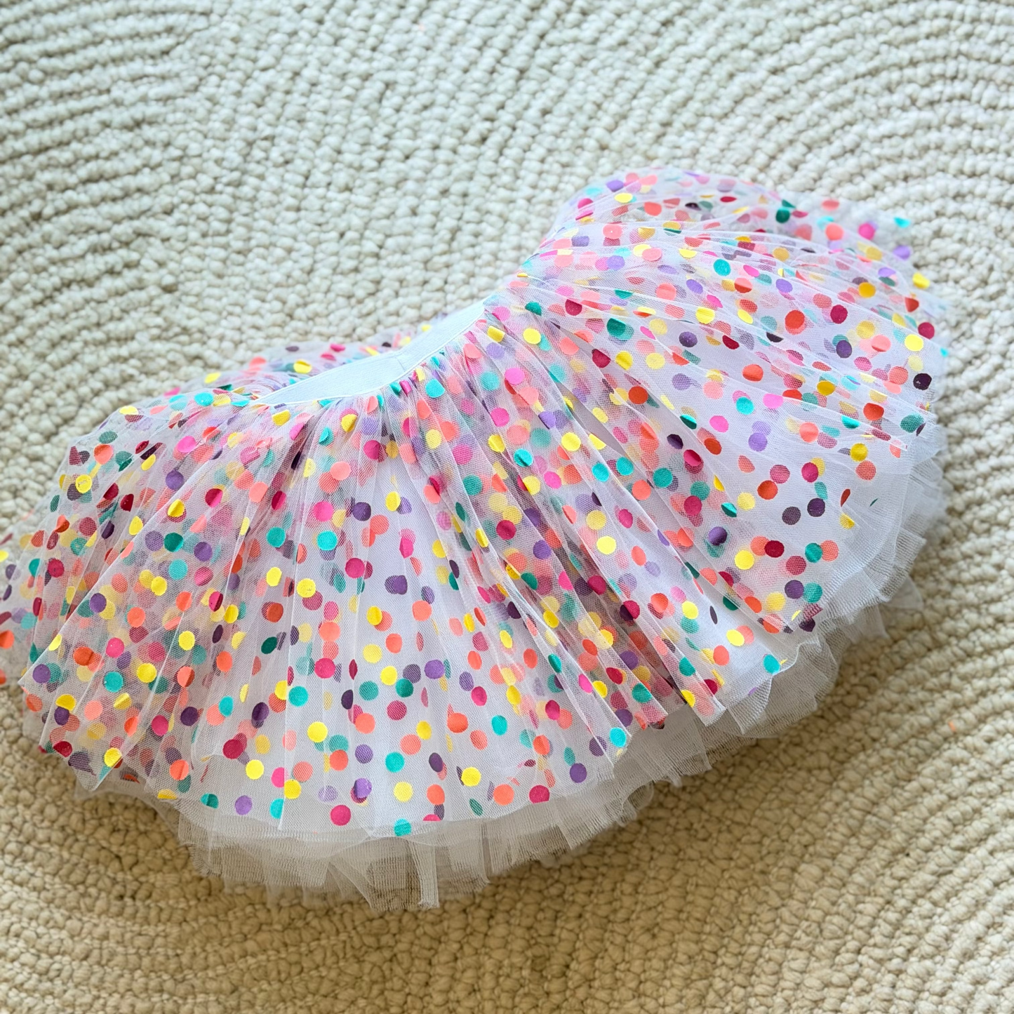 Colorful polka dot tutu on a beige carpet