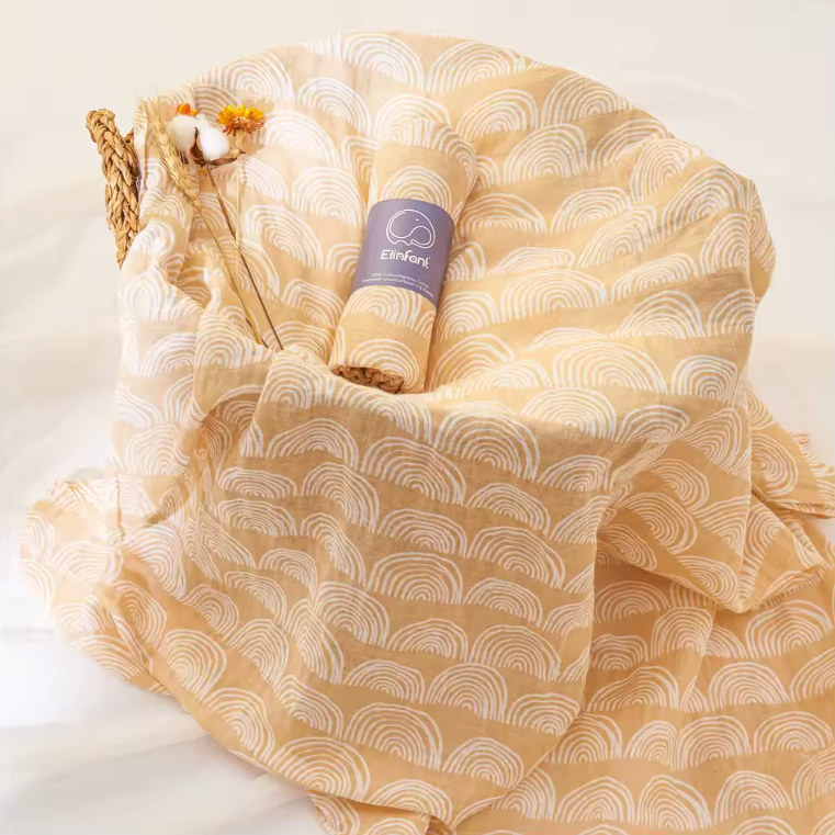 Beige patterned fabric with rolled-up paper and knitting needles on a white background
