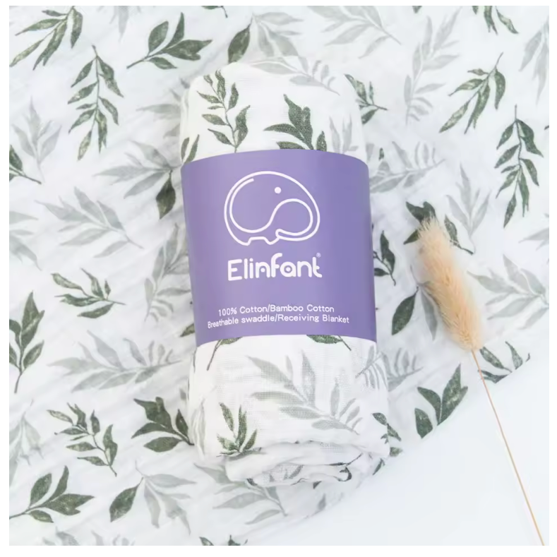 Roll of Elinfant fabric on a leaf-patterned background