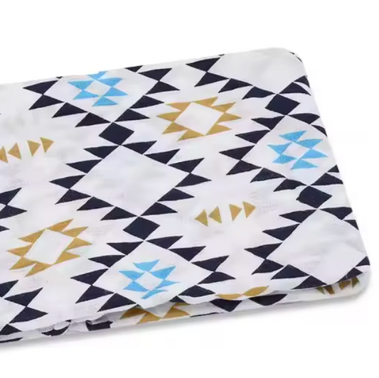 Folded fabric with geometric pattern on a white background