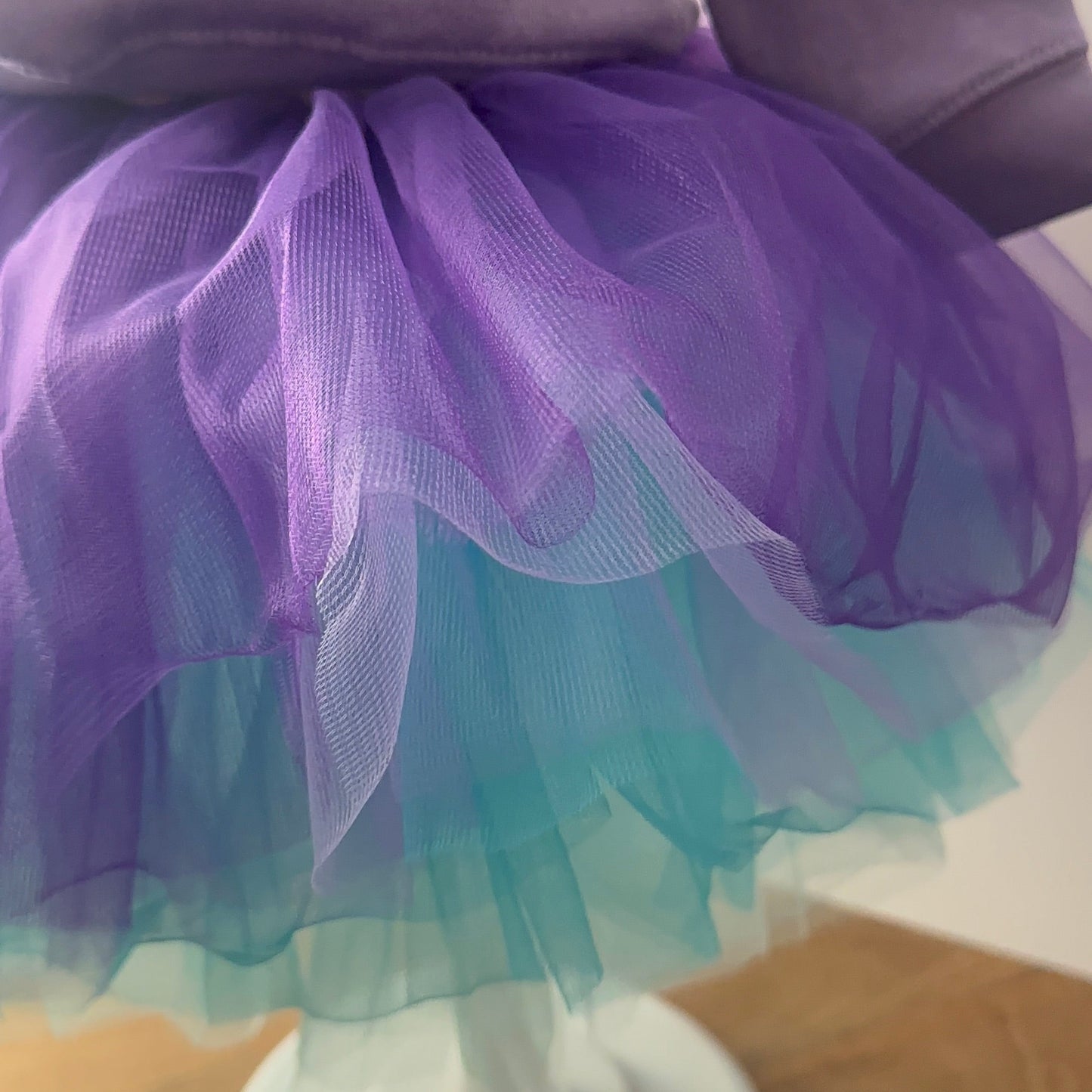 Child's outfit with a purple and blue tutu on a mannequin.