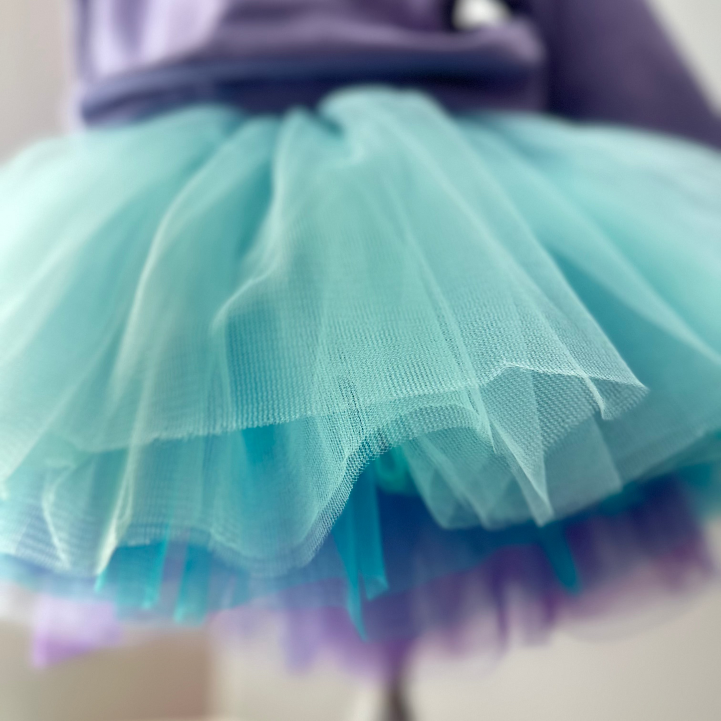 Close-up of a teal tutu skirt with a blurred background