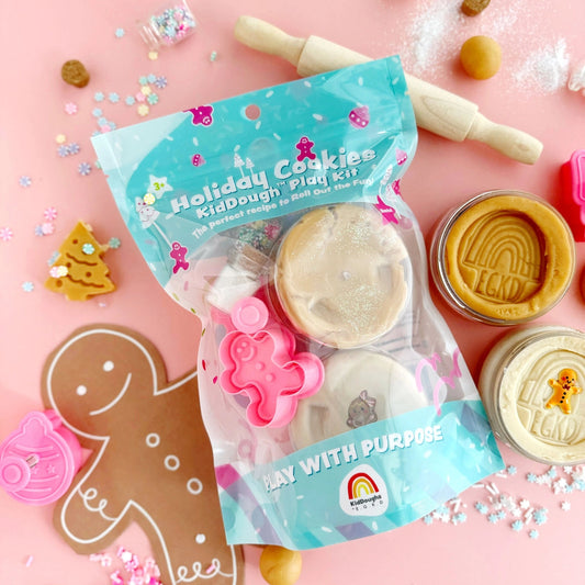 Holiday Cookies Kiddough Play Kit with cookie cutters on a pink background